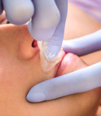procedure for removing hair from a woman over the lip close-up in a beauty salon